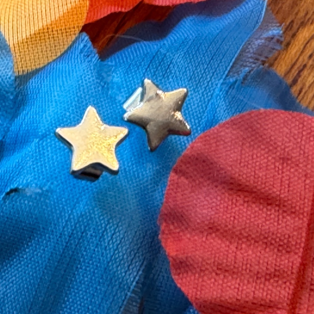 Tiny silver-colored star earrings
